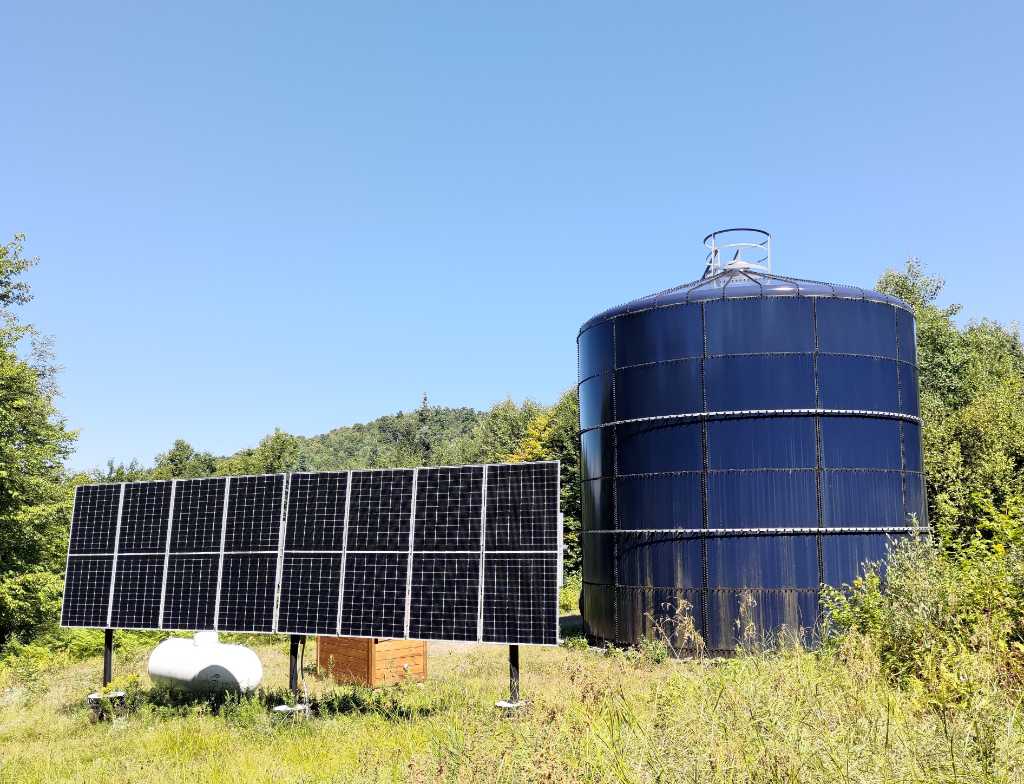 town water tower with solar array to power the internal mixer